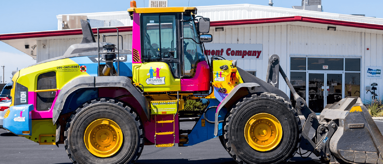 MHQ Graphics has worked with Holmans USA for a long time, putting graphics on their corporate vehicles as well as their community outreach projects. We have twice wrapped heavy duty tractors for them, once for the Wounded Warrior project and again for the Foundation for Autism.