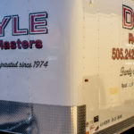 A trailer parked at a work site is a traveling billboard drawing business even as it sits on the street. Doyle Roof Masters uses a simple design to get attention even as they work.